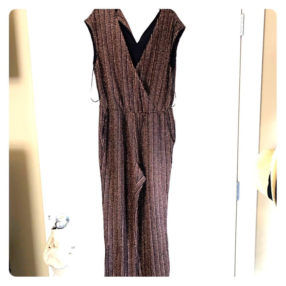 a black jumpsuit with a glittery gold line pattern